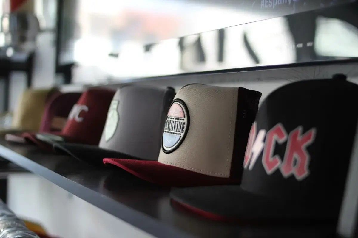 A row of baseball caps displayed on a store shelf