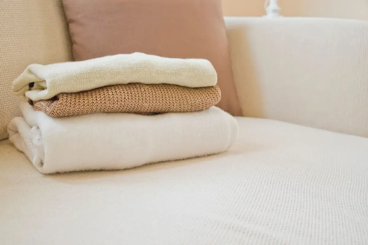 A stack of premium folded apparel, the kind of keepsake that marks a work anniversary