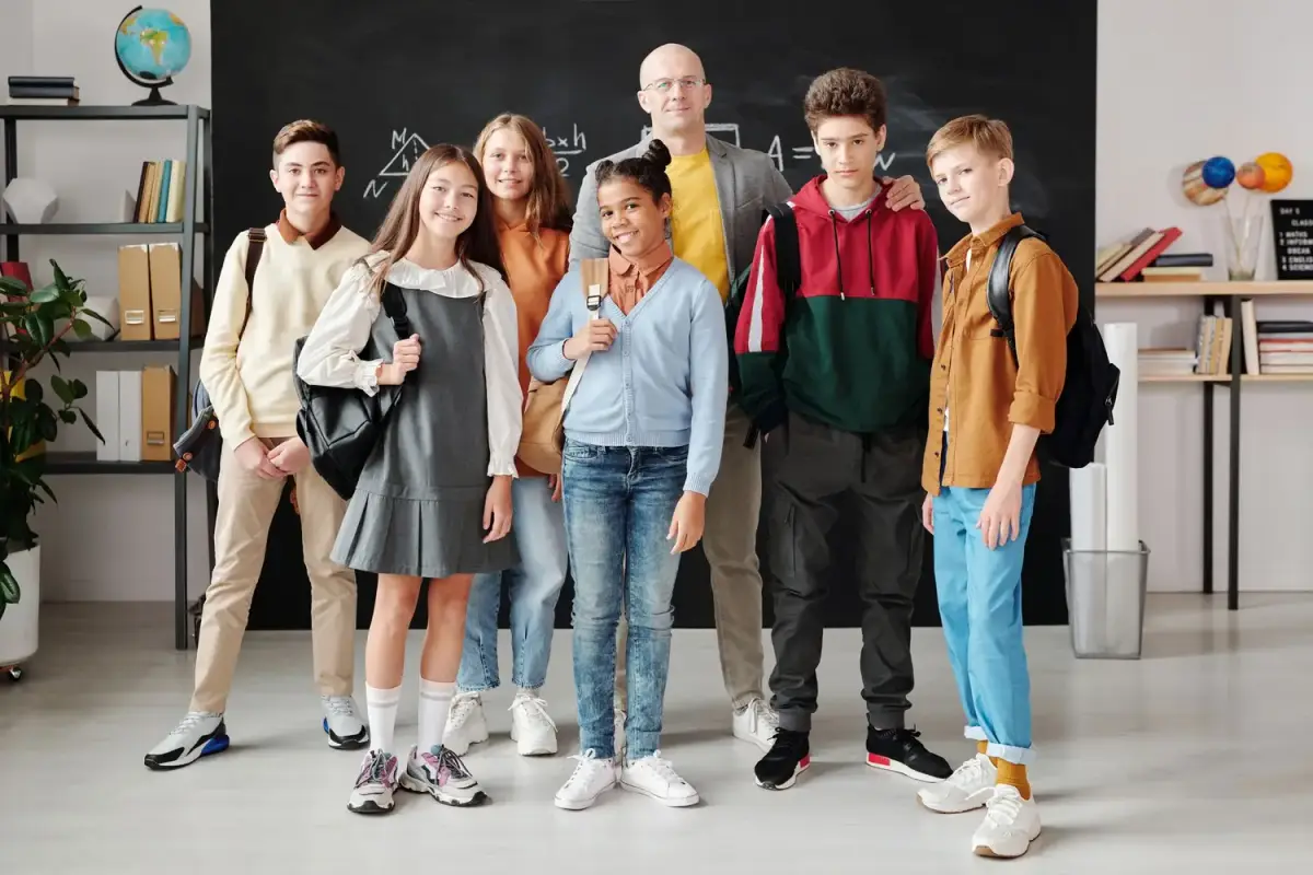 A teacher and students together at school in coordinated apparel