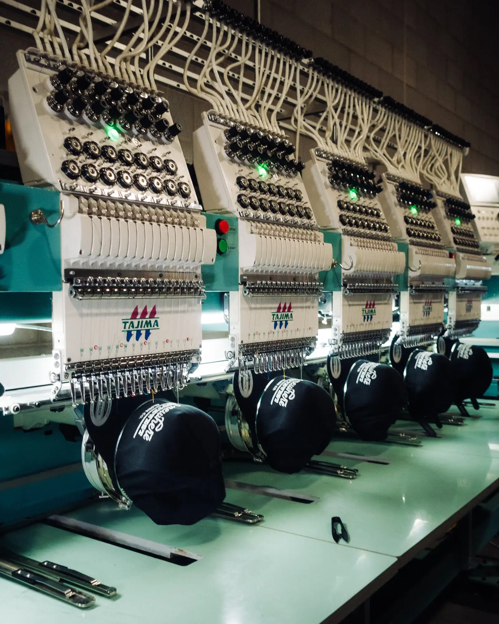Commercial embroidery machines running logo orders in the Heart & Hook shop